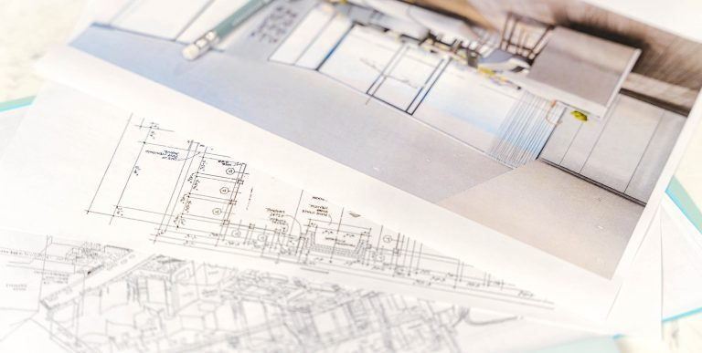 Spread out architectural blueprint or construction drawing with detailed lines, dimensions and text